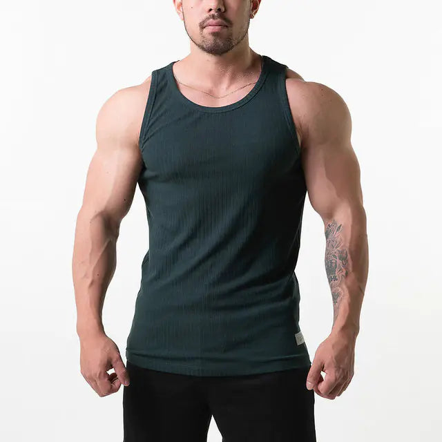 Man wearing a dark green tank top on a white background