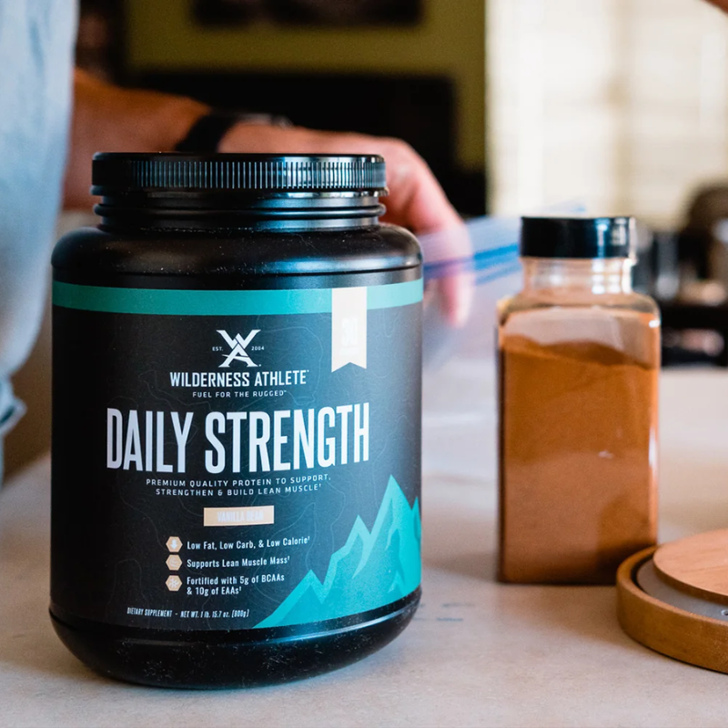 Container of Wilderness Athlete Daily Strength supplement on a table