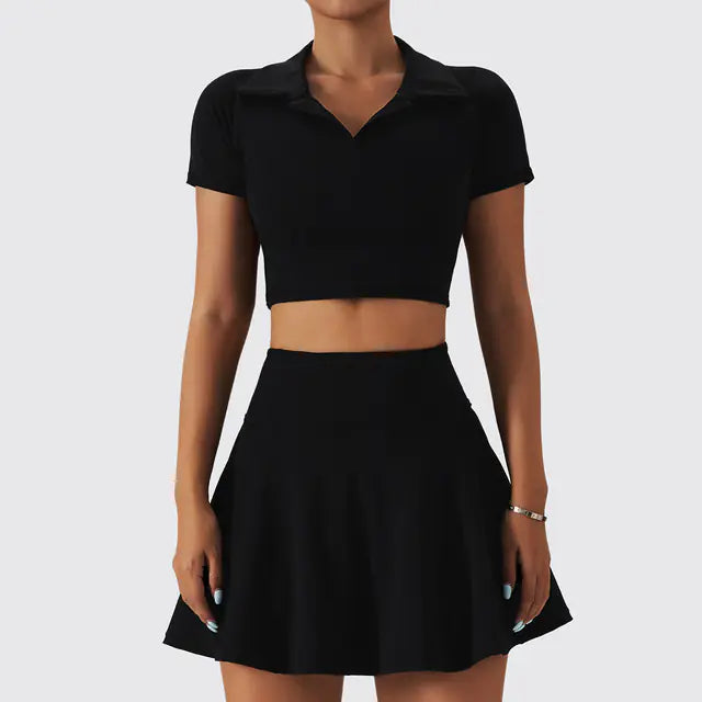 Black crop top and skirt set on a plain background