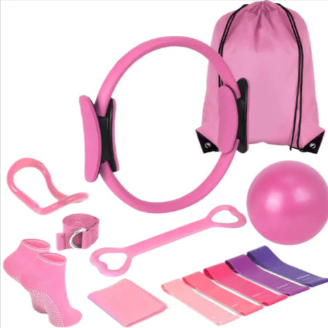 Collection of pink fitness equipment including resistance bands, a ball, and a drawstring bag on a white background.