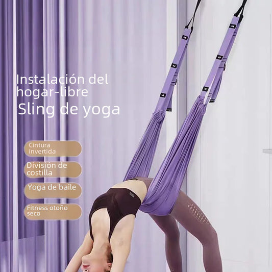 Person using a purple yoga swing against a white curtain background
