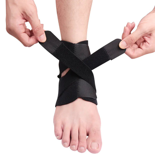 Person applying black tape to a foot on a white background