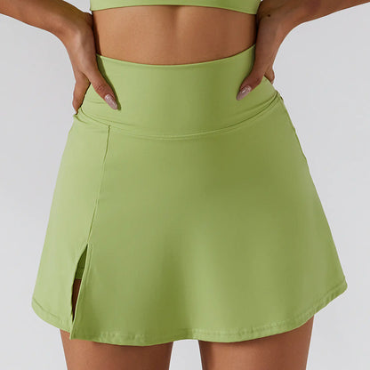 Green skirt worn by a person on a plain background