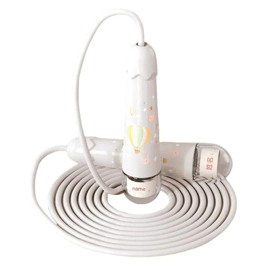 White electronic device with coiled cable on a white background