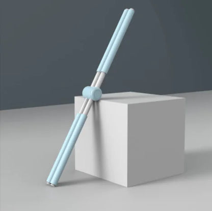Light blue chopsticks on a white block with a gray background