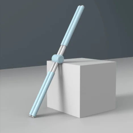 Light blue chopsticks on a white block with a gray background