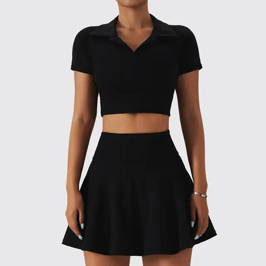 Black crop top and skirt set on a plain background