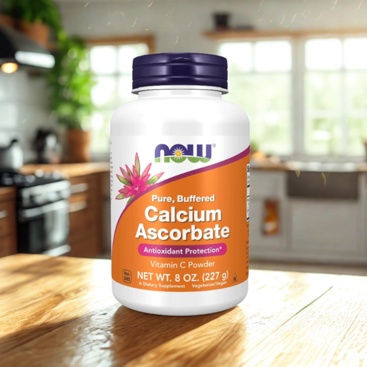 Supplement bottle of NOW Calcium Ascorbate on a kitchen counter